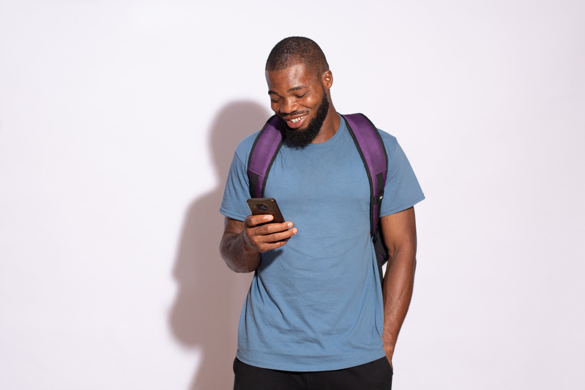 Happy Young Man Using Phone