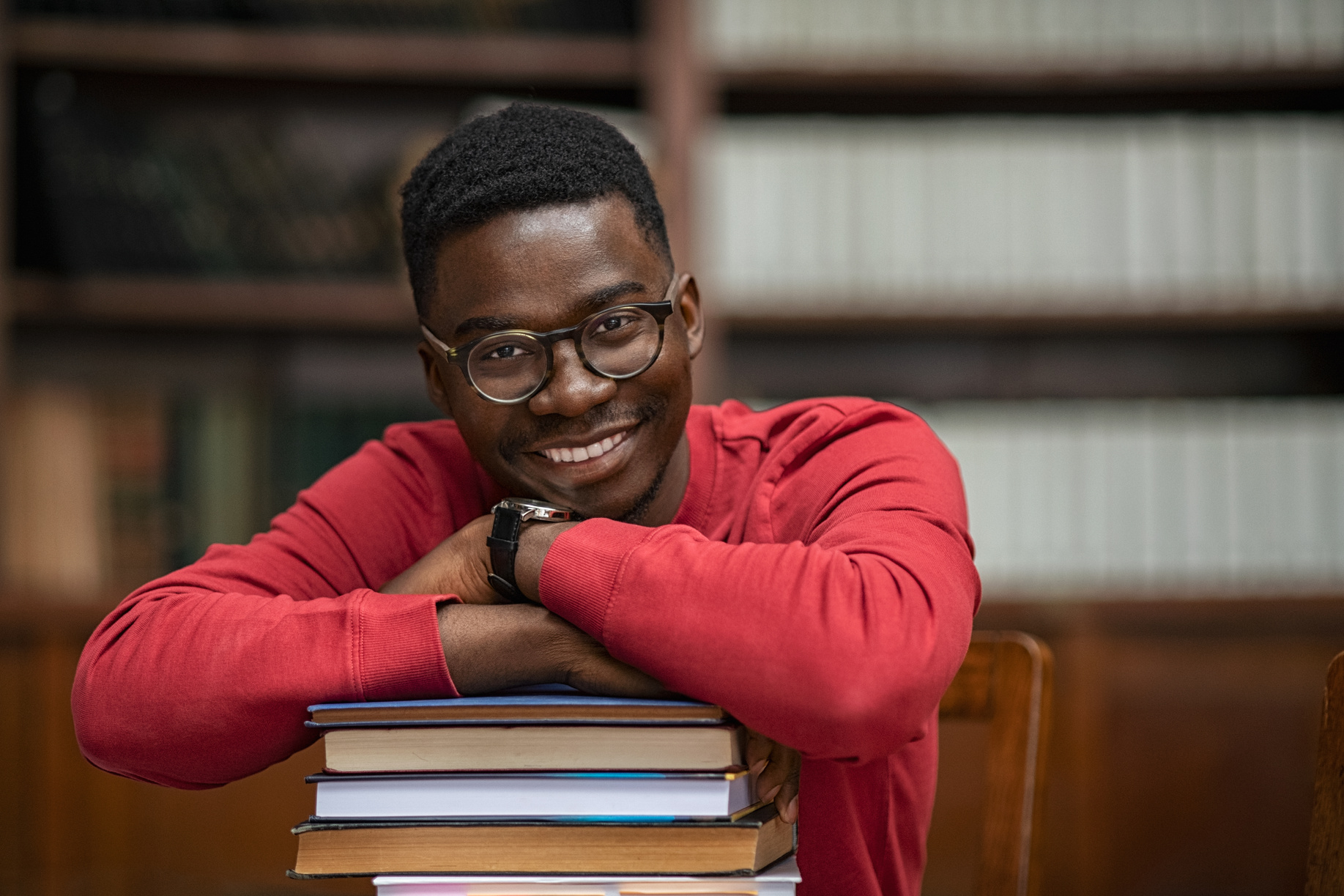 African Student on Pile of Books